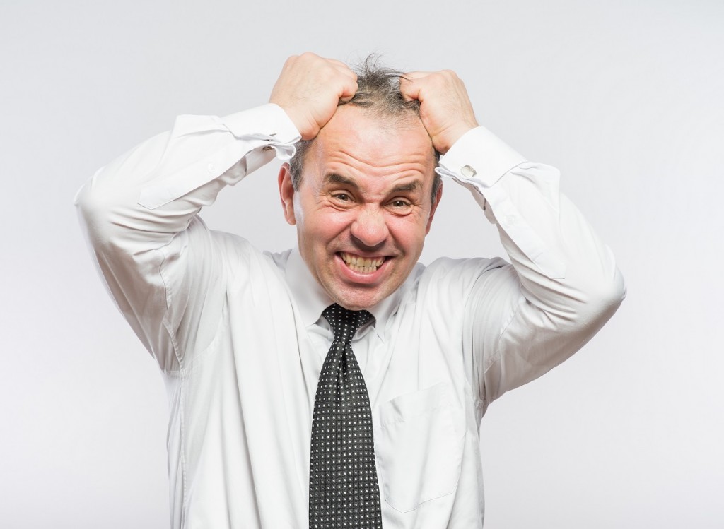Frustrated businessman holding head in his hands