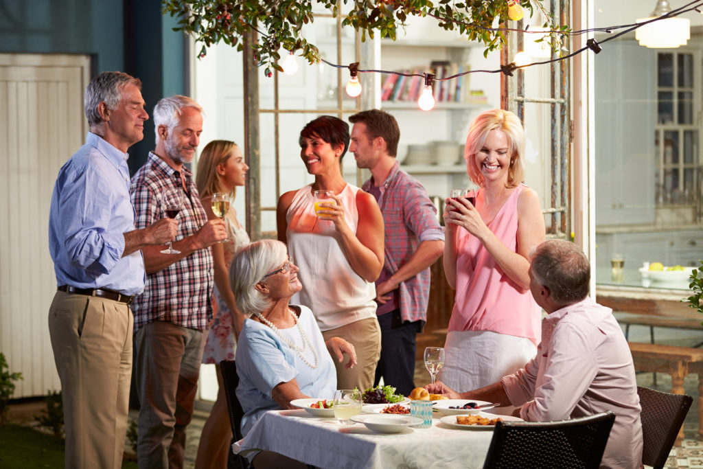 Group Of Friends Enjoying Outdoor Evening Drinks Party