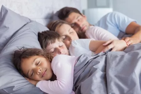 20640603 - cute family sleeping together in bed